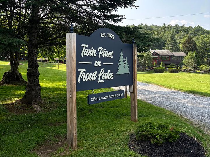 The carved Twin Pines entrance sign